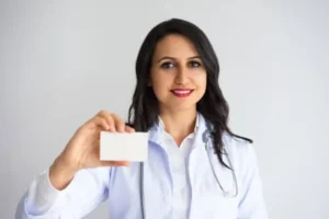 smiling pretty female doctor showing business card 1262 10608